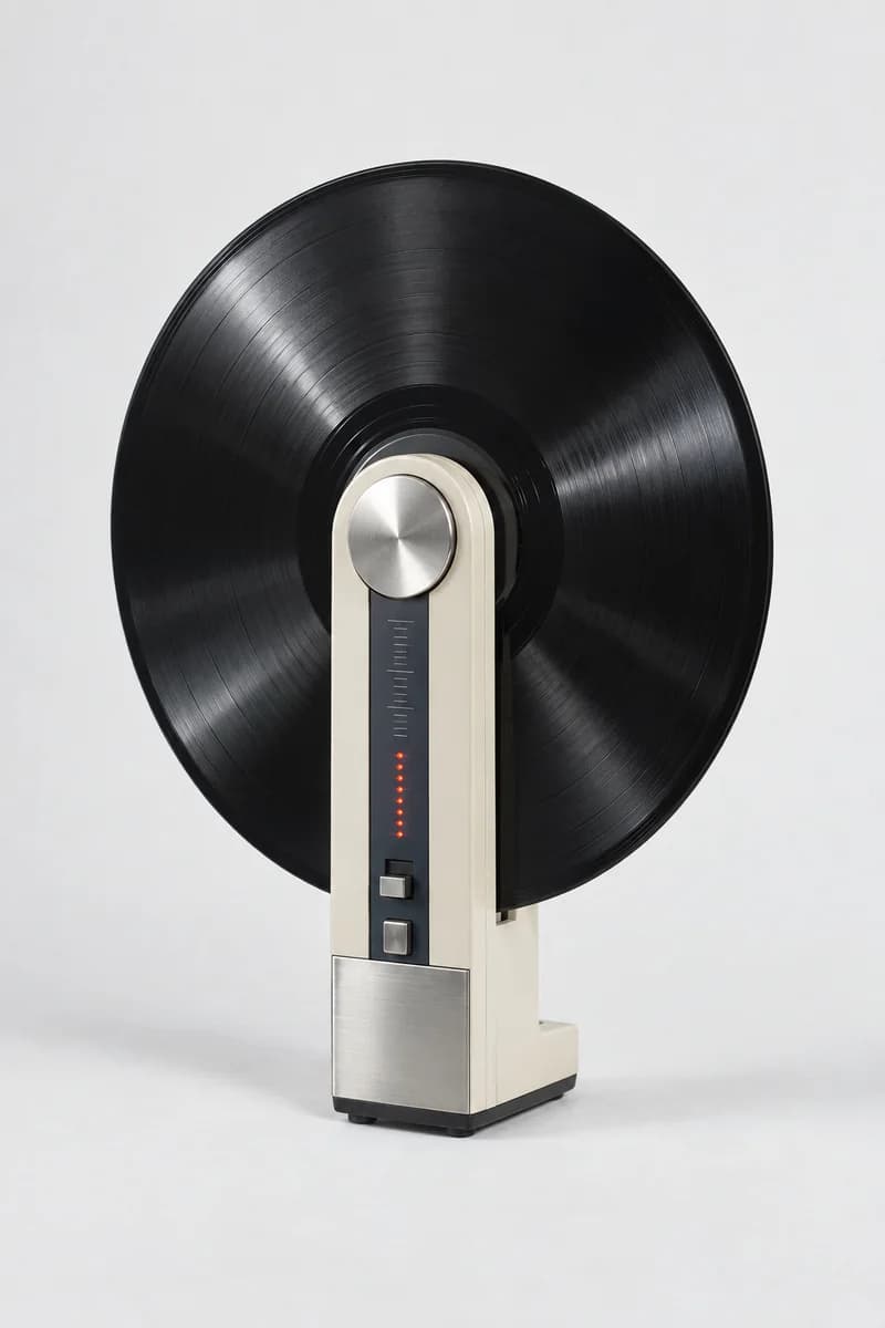 An ivory upright vinyl record player with a black record on a neutral studio backdrop